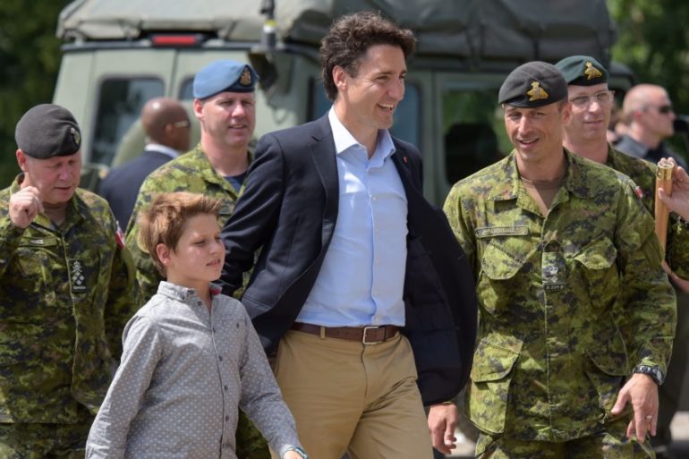 Prime Minister of Canada Justin Trudeau and his son Xavier walk with Canadian soldiers during a visit to a joint military training of Ukrainian and Canadian soldiers in Yavoriv, Ukraine [EPA]