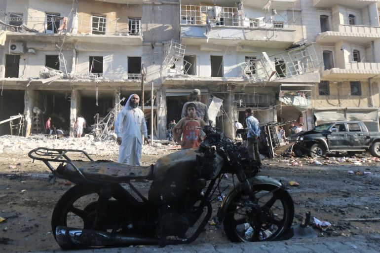 People inspect the damage after an airstrike in the rebel held area of Tariq al-Bab district of Aleppo