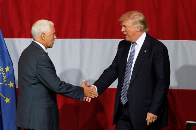 Republican U.S. presidential candidate Donald Trump shakes hands with Indiana Governor Mike Pence before addressing the crowd during a campaign stop at the Grand Park Events Center in Westfield