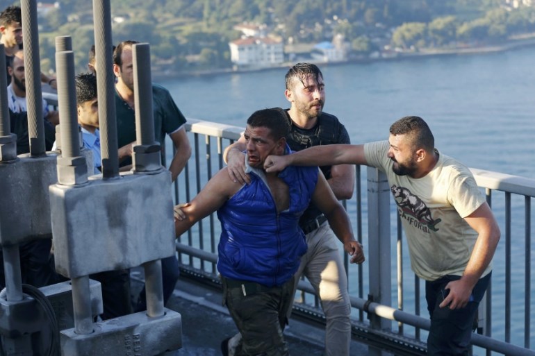 A civilian beats a soldier after troops involved in the coup surrendered on the Bosphorus Bridge in Istanbul