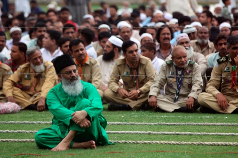 People wait for start of the funeral of Abdul Sattar Edhi at the National Stadium in Karachi