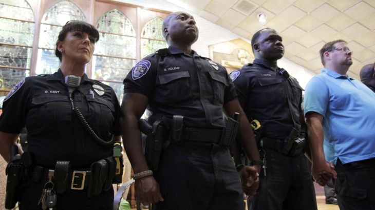 Police officers attend a vigil after a fatal shooting of Baton Rouge policemen, at Saint John the Baptist Church in Zachary