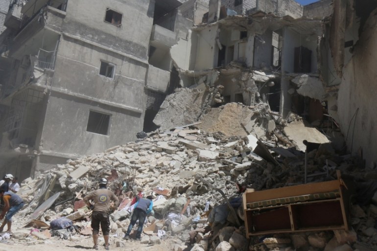 Residents inspect a damaged site after an airstrike on Aleppo''s rebel held Al-Mashad neighbourhood