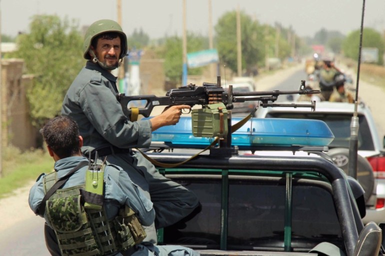 Afghan policemen patrol outside of Kunduz city