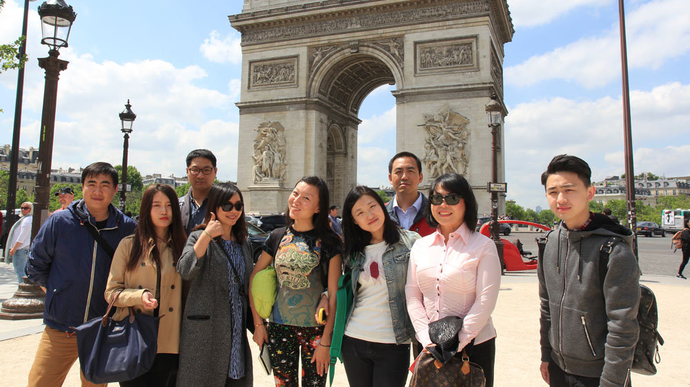 A group of Chinese tour guides in training at the Arc de Triomphe [Al Jazeera]