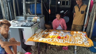 Vendors sell their wares [Bo Gu/Al Jazeera] 