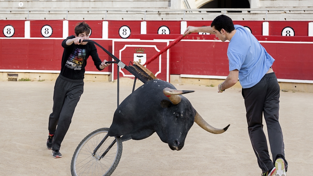 Seventeen-year-old Jesus practises with a fake bull [Jonas Bel/Al Jazeera]