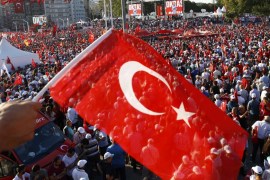 A man waves Turkey''s national flag as he with supporters of various political parties gathers in Istanbul''s Taksim Square