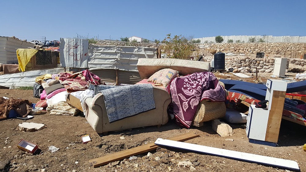 Couches and personal belongings sit in the wreckage of the demolished homes in Anata's Bedouin community [Photos courtesy of UNRWA]