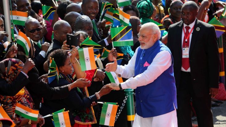 Indian Prime Minister Narendra Modi greets Tanzanians as he arrives at the State House during the official welcoming ceremony in Dar Es Salaam