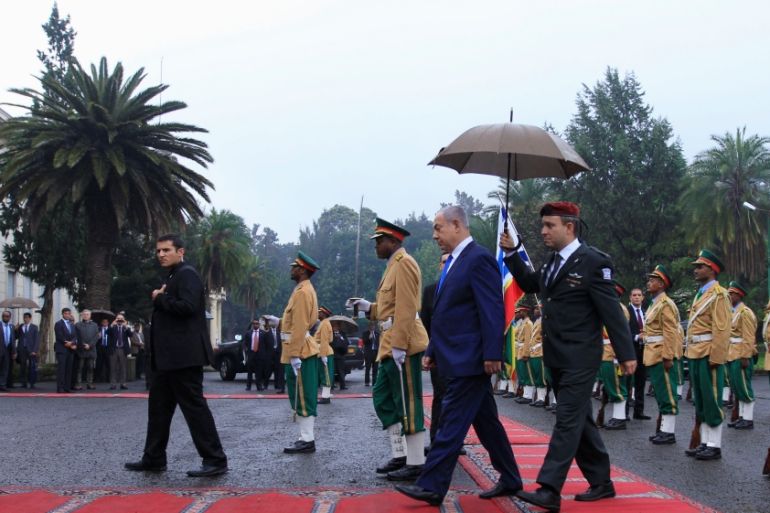 Israeli Prime Minister Netanyahu is escorted after inspecting a guard of honor at the National Palace during his State visit to Addis Ababa, Ethiopia