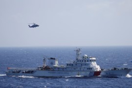 Chinese ship and helicopter are seen during a search and rescue exercise in the South China Sea [Reuters]