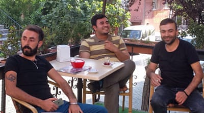 Arif Kavak, left, sits with his friends [Jesse Rosenfeld/Al Jazeera]