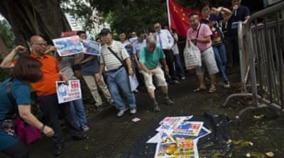Protesters throw eggs at a picture of the US president outside the US Consulate in Hong Kong to protest about the Hague ruling in Hong Kong [EPA]