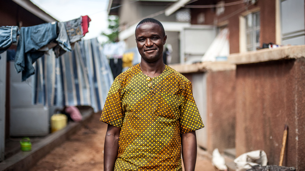 Robert Katende, photographed outside the chess academy in Katwe, one of the largest slums in the Ugandan capital [Aurelie Marrier d'Unienville/Al Jazeera]