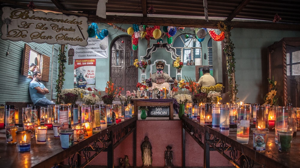 Devotees of San Simon come to this shrine from all over Guatemala to pay tribute and offer gifts of candles and cigars [Gabriela Campos/Al Jazeera] 
