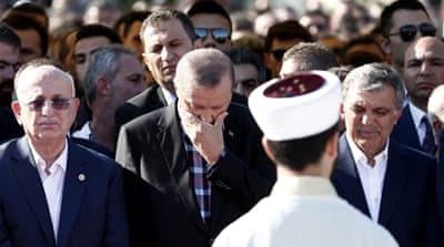 President Recep Tayyip Erdogan and former president Abdullah Gul attend the funeral ceremony of Erol Olcak and his son Abdullah Tayyip Olcak on July 16 [EPA]