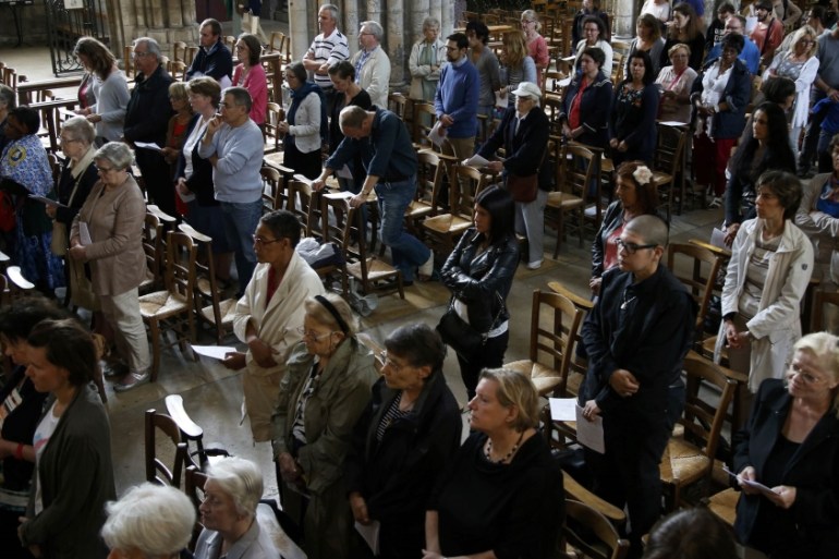 People attend a mass to pay tribute to French priest Father Jacques Hamel at the Cathedral in Rouen in Normandy