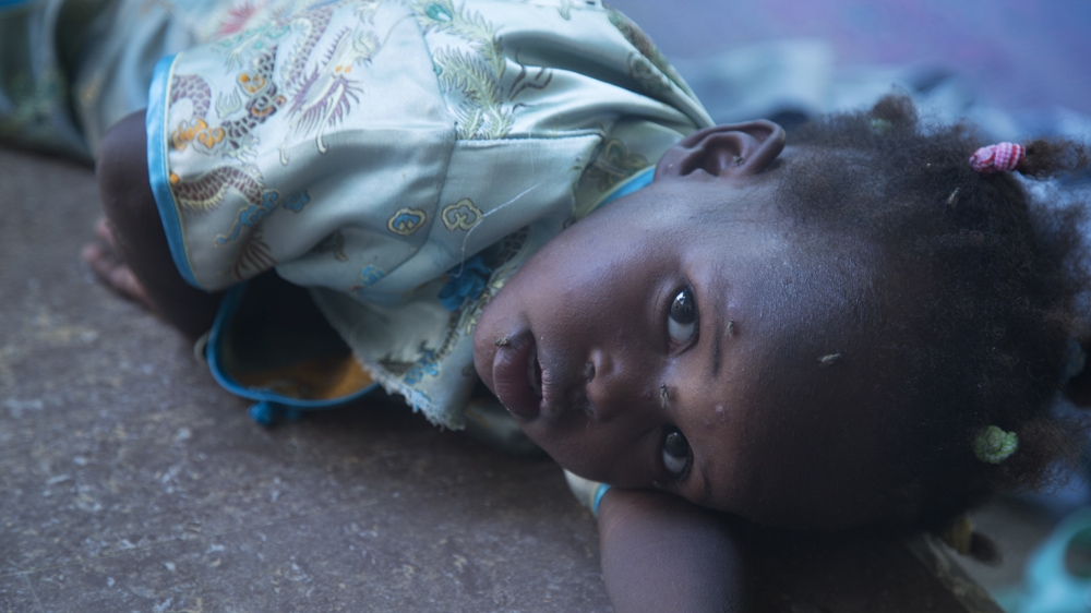 One of the children at the safe house lays down to take a nap [Chika Oduah/Al Jazeera] 