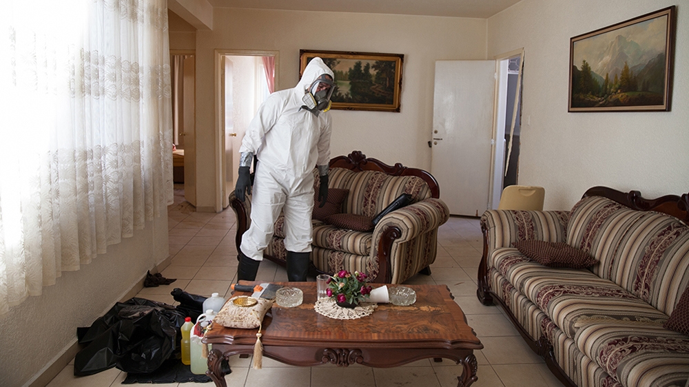 Donovan carries out a forensic cleaning in Mexico City on January 14, 2016. The decomposed body of a man in his 50s was found on the floor of his mother's bedroom days after he had died from an intestinal obstruction [Benedicte Desrus/Al Jazeera]
