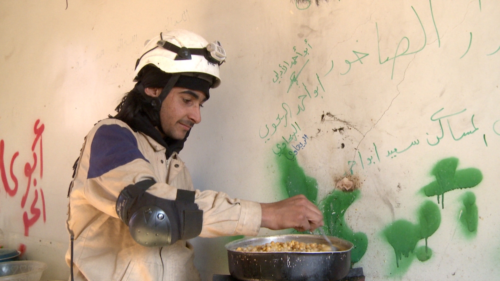 Meshko, 19, one of the youngest on the team, prepares a group meal at the base [Nagieb Khaja/Al Jazeera]