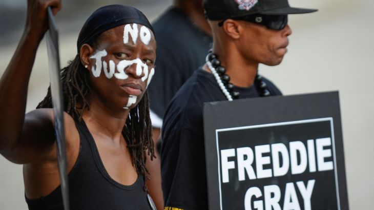 Selah and local artist PFK Boom gather to remember Freddie Gray and all victims of police violence during a rally outside city hall in Baltimore