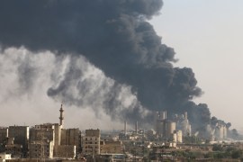 A general view shows rising smoke from a Syrian regime controlled cement factory, in Aleppo
