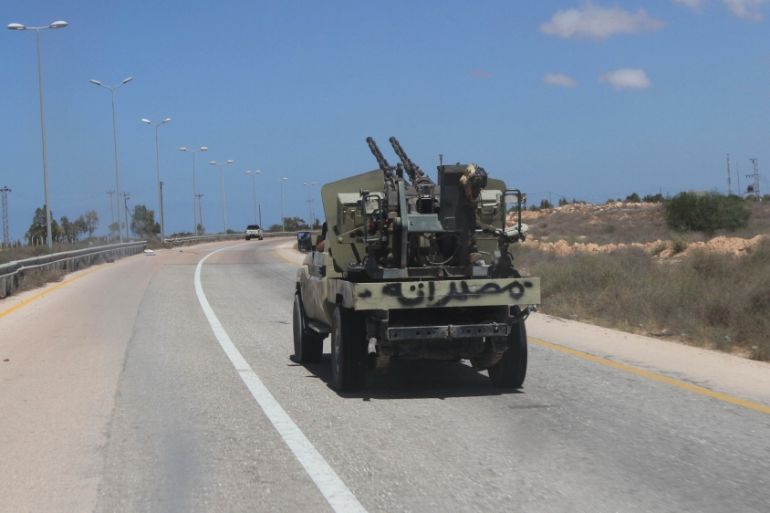 Fighter from Libyan forces allied with the U.N.-backed government drives a military truck in Sirte