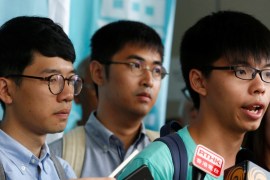 Student leader Joshua Wong speaks beside Alex Chow and Nathan Law after a verdict in Hong Kong