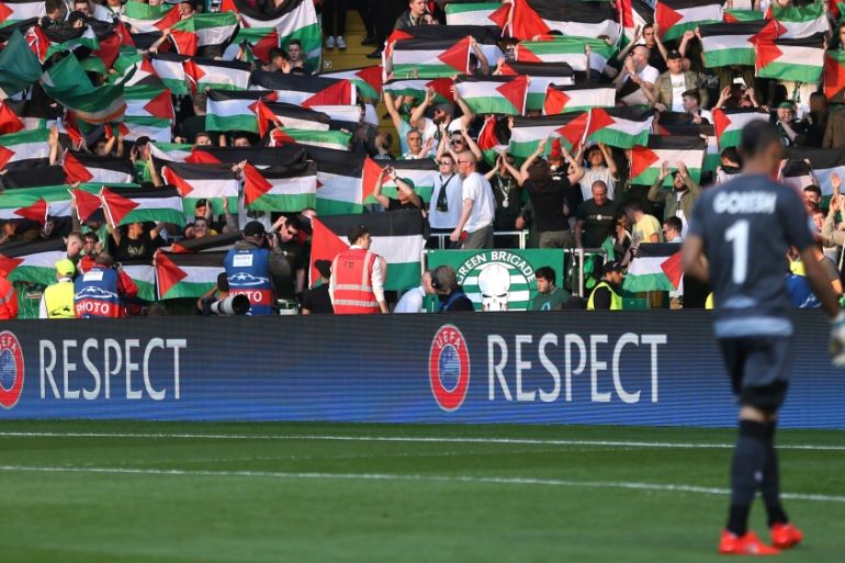 Celtic fans hold up Palestine flags