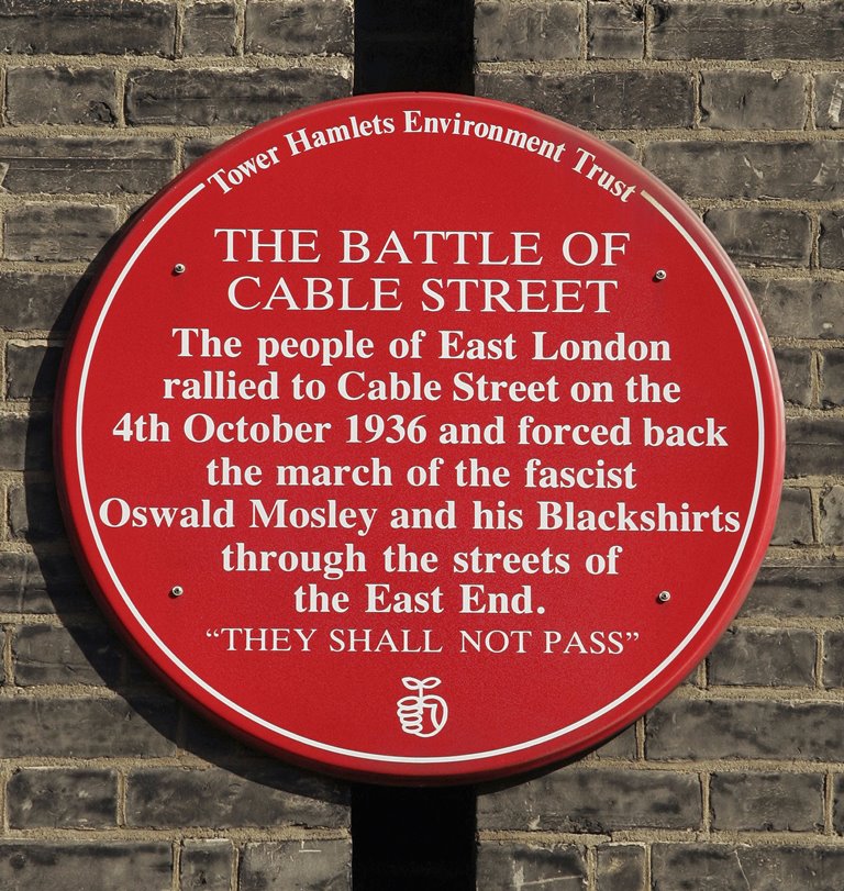 A plaque commemorating the Battle of Cable Street is mounted on a wall in London, England [Peter Macdiarmid/Getty Images]