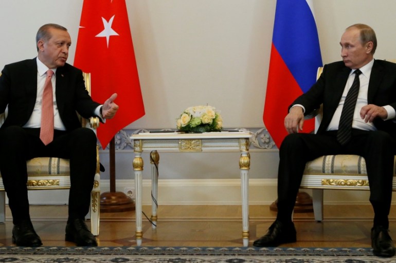 Turkish President Erdogan speaks to Russian President Putin during their meeting in St. Petersburg