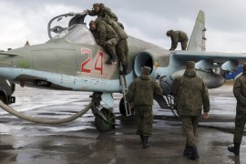 Support personnel prepare Russian Su-25 at Hmeymim airbase