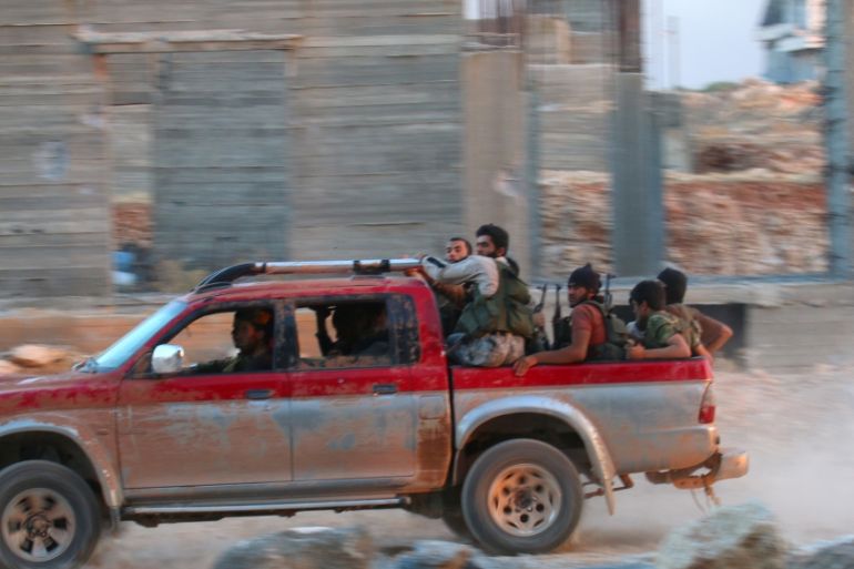 Fighters of the Syrian Islamist rebel group Jabhat Fateh al-Sham, the former al Qaeda-affiliated Nusra Front, ride on a pick-up truck in the 1070 Apartment Project area in southwestern Aleppo