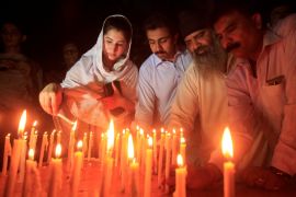 Residents light candles to honour victims of the blast in Quetta during a candellight vigil in Peshawar