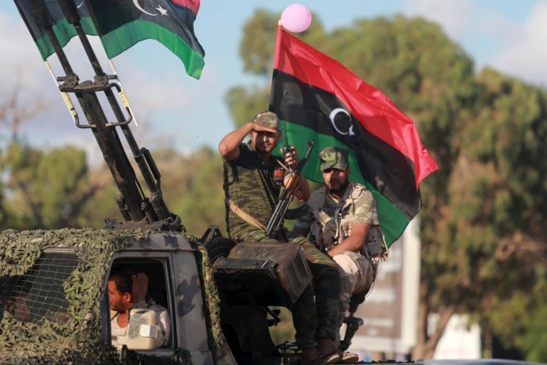 Members of the Libyan army give protection to a demonstration in support of the Libyan army under the leadership of General Khalifa Haftar, in Benghazi