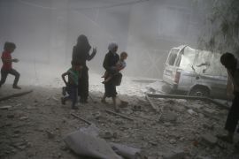 Residents flee a site after an air strike on the rebel-held besieged town of Douma, eastern Damascus suburb of Ghouta