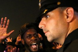 A protester shouts "Look at me" towards a NYPD police officer during a march against police brutality in Manhattan, New York, U.S.