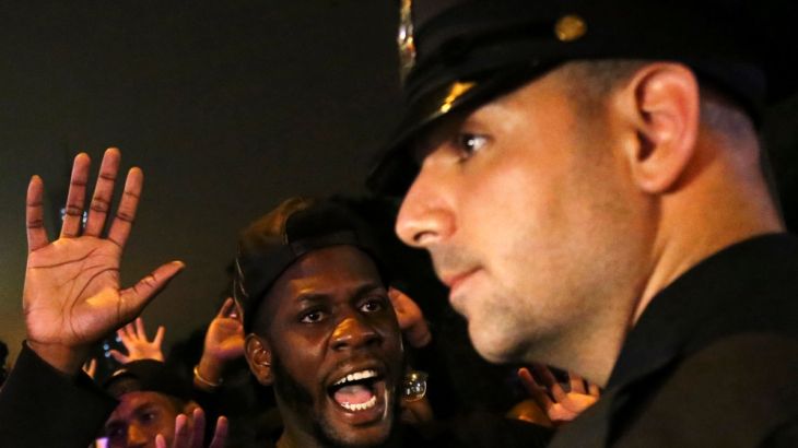 A protester shouts "Look at me" towards a NYPD police officer during a march against police brutality in Manhattan, New York, U.S.
