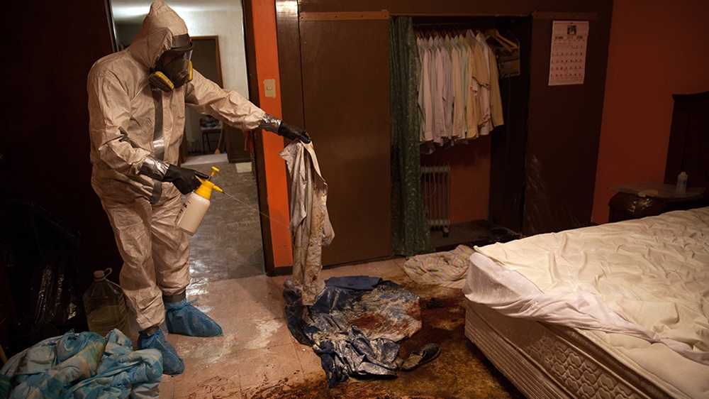 Donovan carries out a forensic cleaning of the scene of an unsolved homicide in Cuernavaca, Morelos, one of Mexico's most dangerous cities [Benedicte Desrus/Al Jazeera]