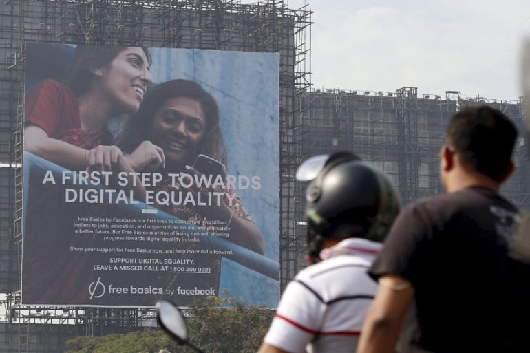 File photo of motorists riding past a billboard displaying Facebook''s Free Basics initiative in Mumbai, India