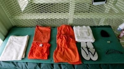 A uniform and other supplies that are given to detainees lie on a bed in a cell at Camp Delta at Guantanamo Naval Base in Guantanamo, Cuba [Getty]