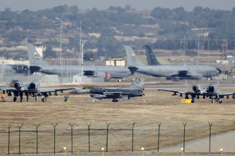 A Turkish Air Force F-16 fighter jet is seen between U.S. Air Force A-10 Thunderbolt II fighter jets at Incirlik airbase in Adana, Turkey