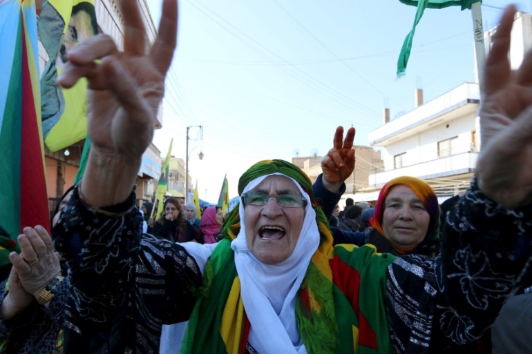 Kurdish women gesture and shout slogans during a demonstration against the exclusion of the Syrian Kurds from the Geneva talks, in the northeast Syrian Kurdish city of Qamishli