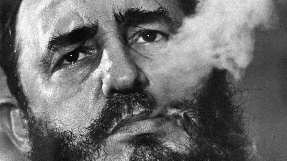 Castro smokes a cigar during an interview in Havana, 1945 [Charles Tasnadi/AP]
