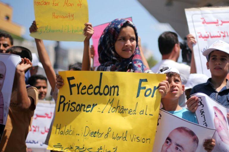 Palestinian demonstrators take part in a protest in solidarity with Mohammad El Halabi, World Vision''s manager of operations in Gaza, organised by foundations and societies benefiting from World Visi