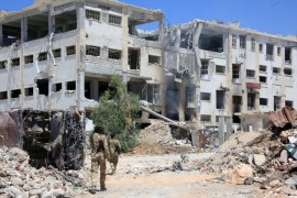Forces loyal to Syria''s President Bashar al-Assad walk past rubble after they advanced on the southern side of the Castello road in Aleppo