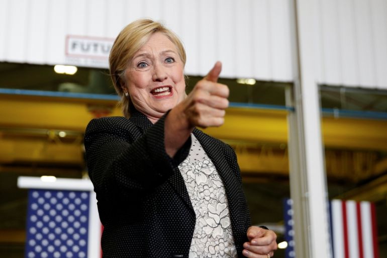 U.S. Democratic presidential nominee Hillary Clinton gives a thumbs up to supporters as she is introduced at Futuramic Tool & Engineering in Warren