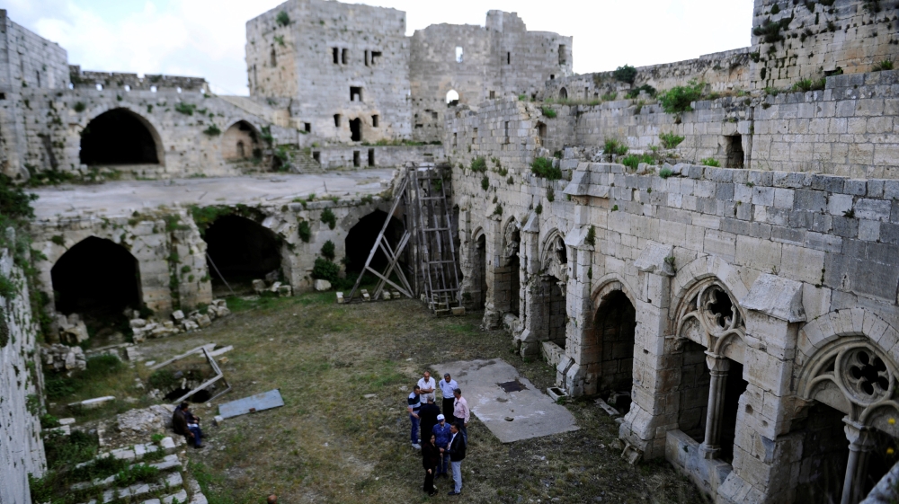 Experts gather as they discuss the restoration process of the Crusader castle of Crac des Chevaliers, which was heavily damaged by bombing [Omar Sanadiki/Reuters]
