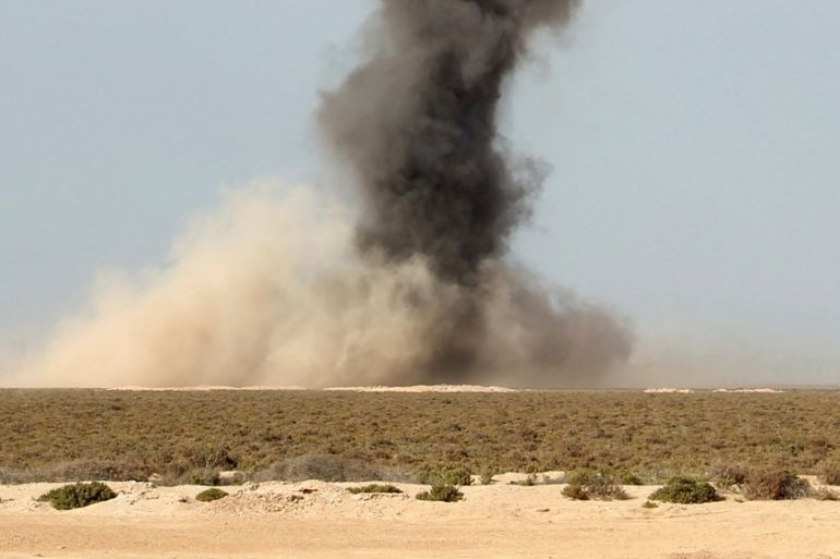 Smoke rises as Libyan forces dispose of explosives left behind by Islamic State militants following a battle in Sirte, at Misrata, Libya [Reuters]